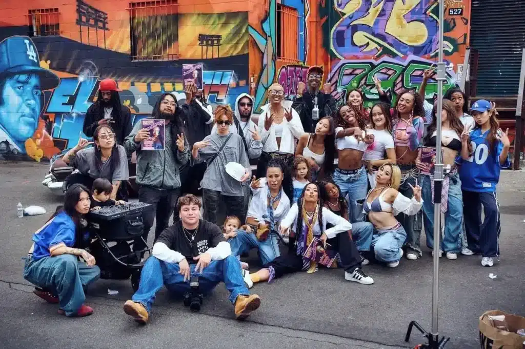 Group photo of a large hip-hop community gathering outdoors, documenting a 4SHOOTERS-related set with performers and friends.