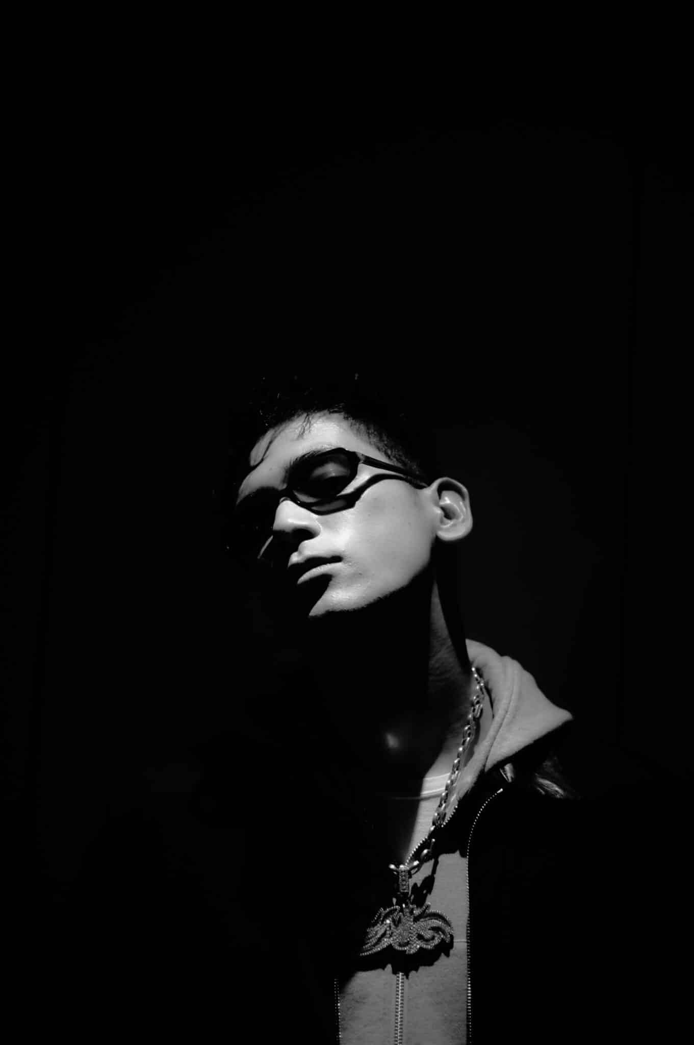 Close portrait of JIRO photographed in low-key monochrome lighting