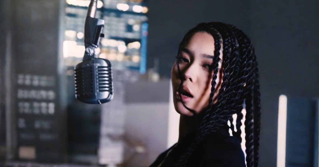 Alif Wolf beside a suspended vintage microphone in a portrait supplied for the HIPHOPCs interview