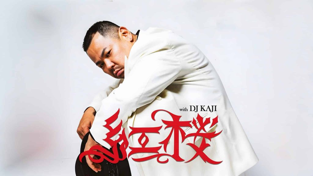 BENIZAKURA crouching in a white suit and holding a black hat, with a large red logo and the words with DJ KAJI