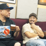 MEGA-G and Greedy on ILLBLOCK talking on a sofa