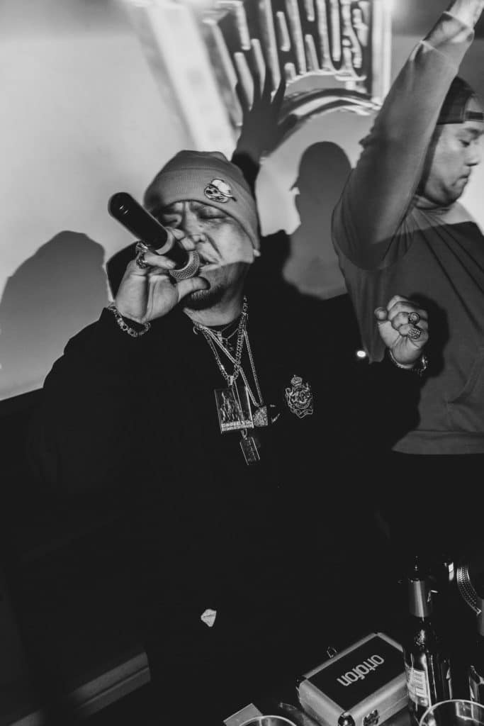 MEGA-G rapping onstage with a microphone