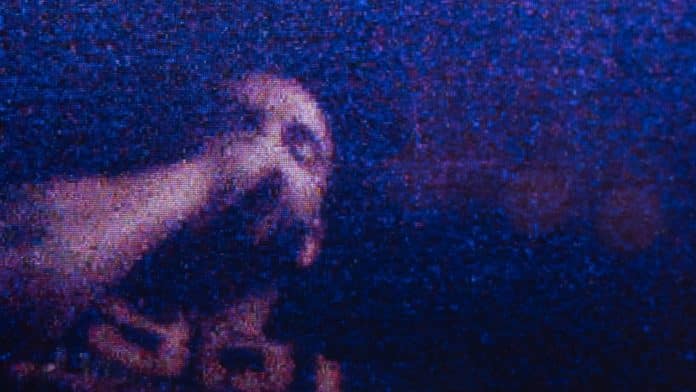 青と紫の光の中に写るDrake。公式Instagramの映像作品『FOMO』告知写真。